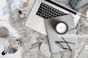 Laptop, Notebook & Candle on Grey Workspace. Stock Image