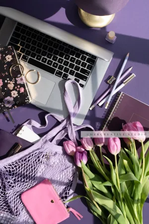Pink Tulips & Laptop on Purple. Stock Photo.
