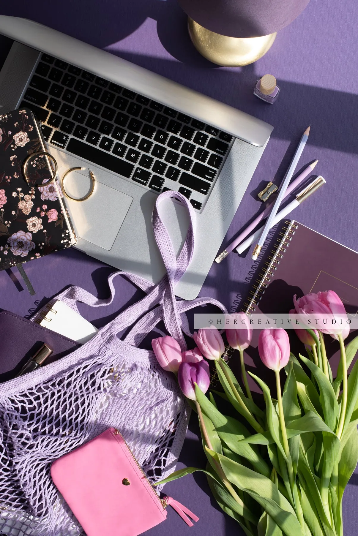 Pink Tulips & Laptop on Purple. Stock Photo.